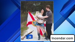 Maternity photo shows mom-to-be posing with gator shotgun and beer. Because Florida.